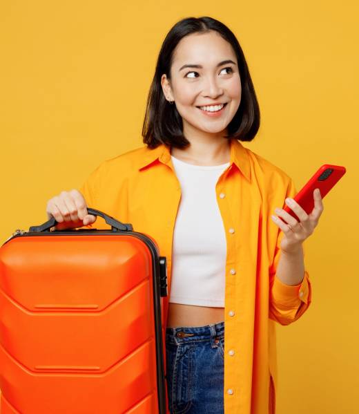 Young woman wear summer casual clothes hold mobile cell phone bag look aside isolated on plain yellow background. Tourist travel abroad in free spare time rest getaway. Air flight trip journey concept